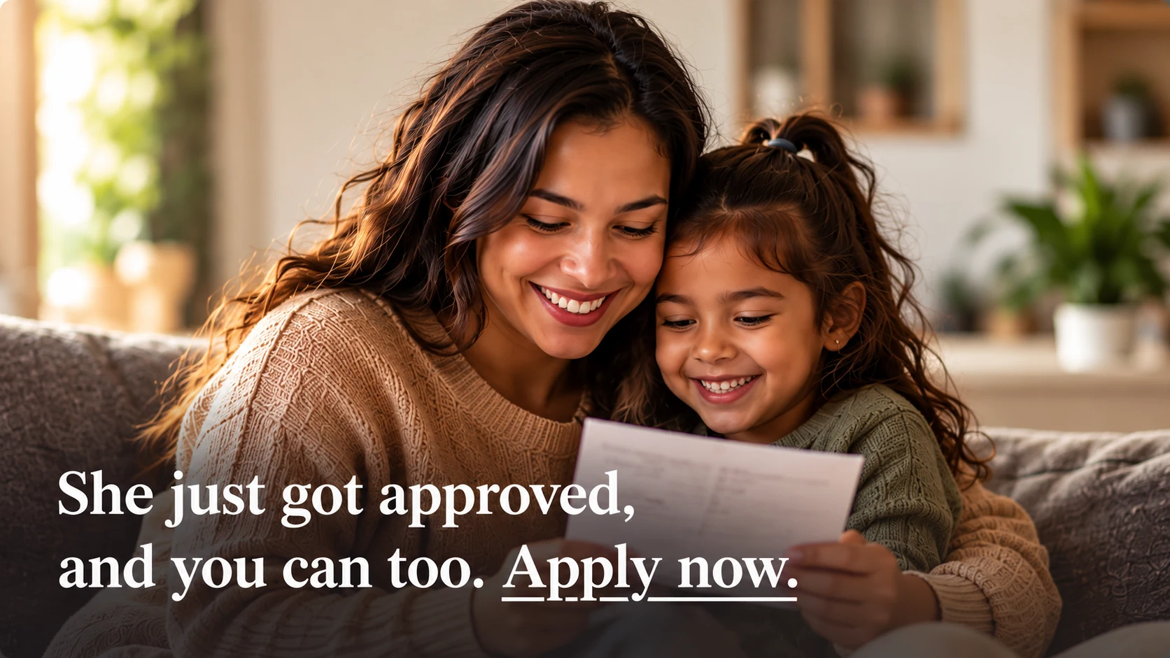 A smiling mother and daughter reading an approval letter together